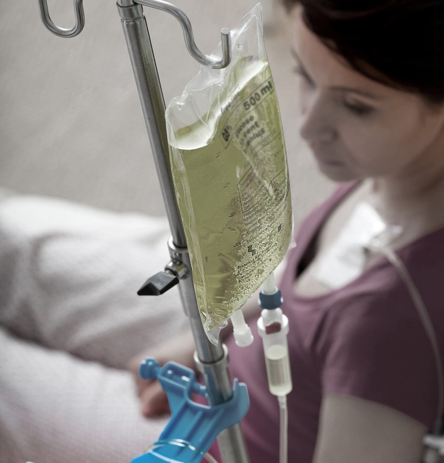 Female patient hooked up to IV infusion pump illustrative of lymphodepletion